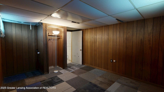 5120 Wardcliff Dr, East Lansing, MI 48823 - spare room with a drop ceiling and wood walls