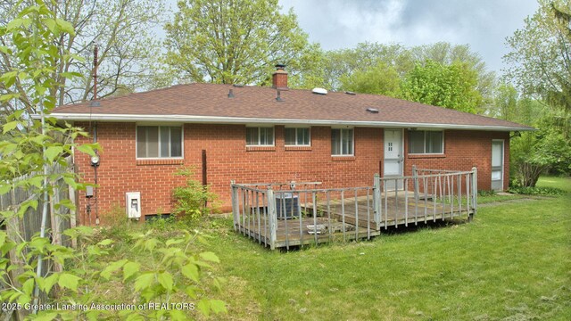 5120 Wardcliff Dr, East Lansing, MI 48823 - back of property featuring a deck, brick siding, a lawn, a chimney, and a shingled roof