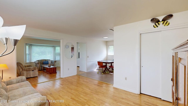 5120 Wardcliff Dr, East Lansing, MI 48823 - living room with light wood-style flooring and baseboards