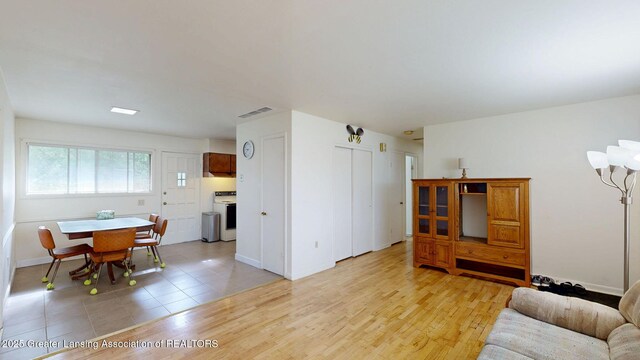 5120 Wardcliff Dr, East Lansing, MI 48823 - living room featuring baseboards and light tile patterned floors