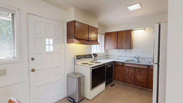 5120 Wardcliff Dr, East Lansing, MI 48823 - kitchen featuring white appliances, under cabinet range hood, a sink, and light countertops