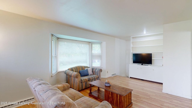 5120 Wardcliff Dr, East Lansing, MI 48823 - living area with healthy amount of natural light, light wood-style flooring, built in shelves, and baseboards