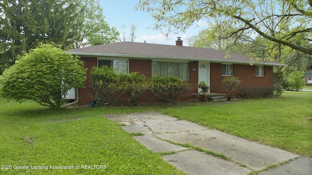 5120 Wardcliff Dr, East Lansing, MI 48823 - single story home with a front yard, a chimney, and brick siding