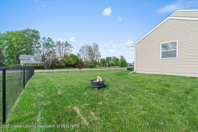 view of yard with an outdoor fire pit