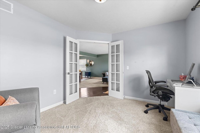 carpeted home office featuring french doors and baseboards