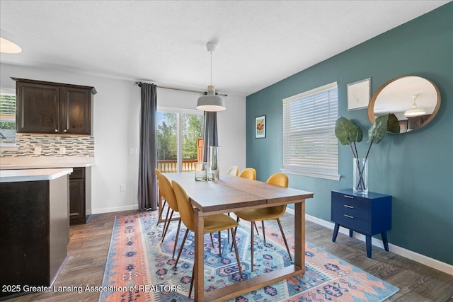 dining area featuring dark wood-style floors and baseboards