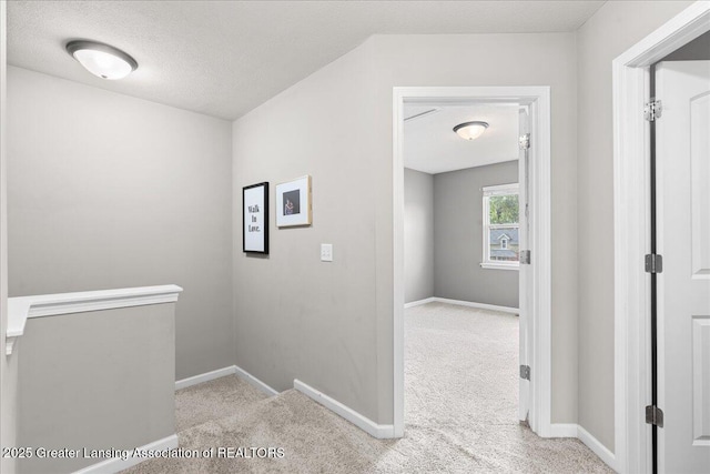 hall with carpet floors and baseboards
