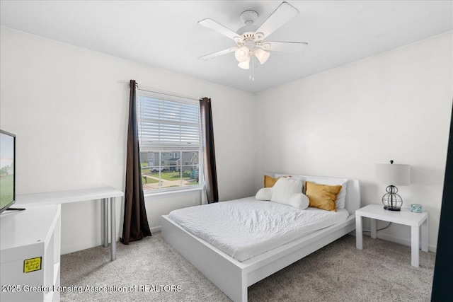 bedroom with light colored carpet and a ceiling fan