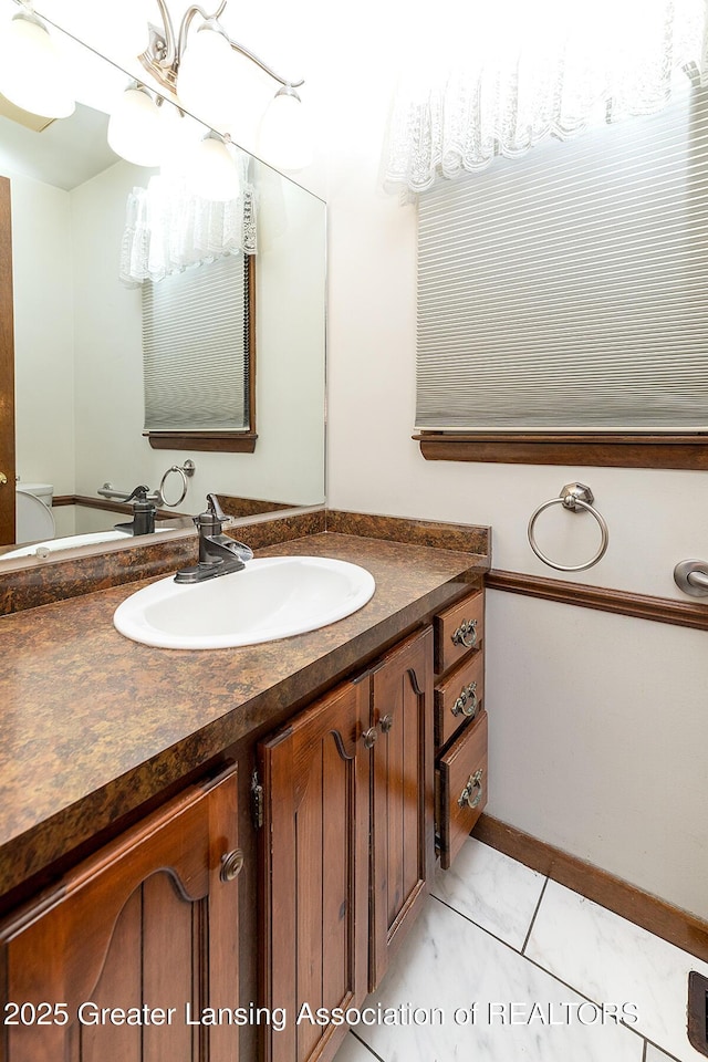 bathroom with vanity and baseboards
