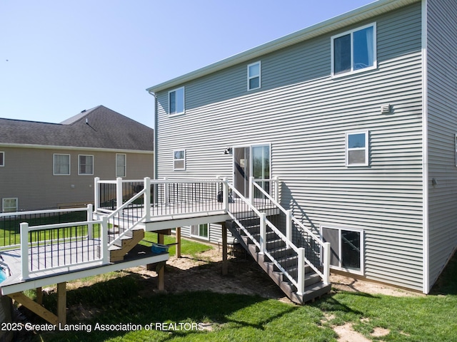 3793 Calypso Rd, Holt, MI 48842 - rear view of property featuring stairs, a deck, and a lawn
