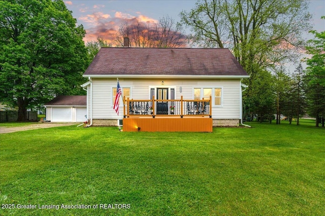 1614 Gunn Rd, Holt, MI 48842 - view of front facade with a wooden deck, a front lawn, dirt driveway, and a garage