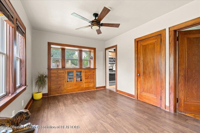 1614 Gunn Rd, Holt, MI 48842 - empty room featuring wood finished floors, a ceiling fan, and baseboards