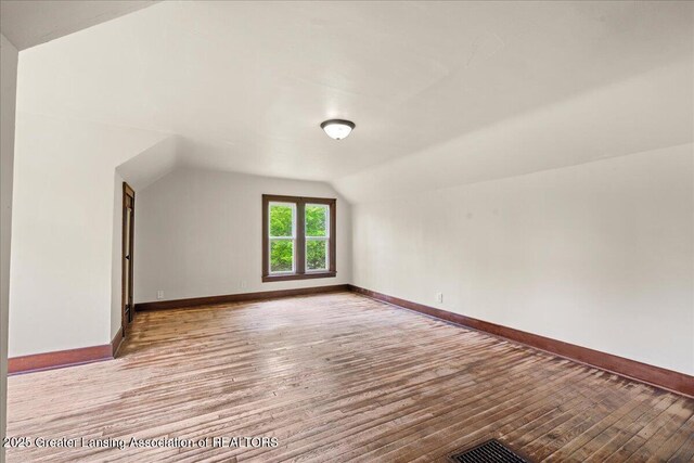 1614 Gunn Rd, Holt, MI 48842 - additional living space featuring wood finished floors, lofted ceiling, and baseboards