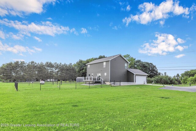 4535 Harper Rd, Holt, MI 48842 - view of yard with asphalt driveway and view of scattered trees