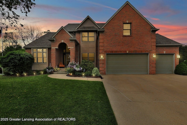 3650 Observatory Ln, Holt, MI 48842 - traditional home with brick siding, a front lawn, concrete driveway, a shingled roof, and a garage