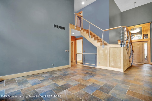 3650 Observatory Ln, Holt, MI 48842 - entrance foyer featuring a high ceiling, baseboards, stairs, stone finish floors, and recessed lighting