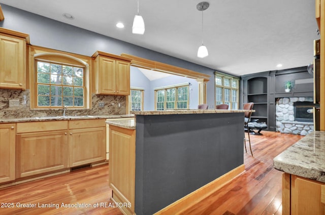 3650 Observatory Ln, Holt, MI 48842 - kitchen with a sink, light wood-style floors, light brown cabinets, recessed lighting, and lofted ceiling