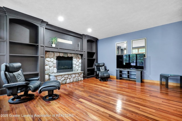 3650 Observatory Ln, Holt, MI 48842 - living room with a fireplace, wood finished floors, recessed lighting, and baseboards