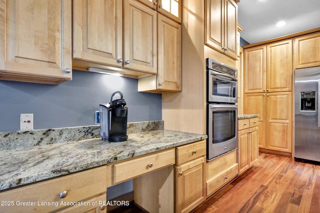 3650 Observatory Ln, Holt, MI 48842 - kitchen featuring stainless steel appliances, light brown cabinets, light wood-style floors, light stone countertops, and recessed lighting