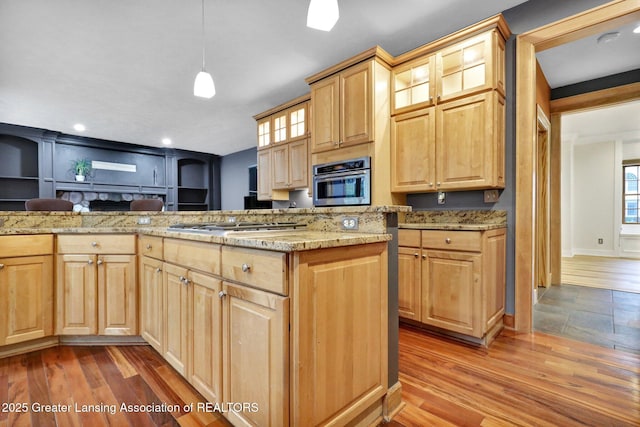3650 Observatory Ln, Holt, MI 48842 - kitchen featuring light brown cabinetry, glass insert cabinets, light wood-type flooring, and recessed lighting