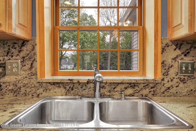 3650 Observatory Ln, Holt, MI 48842 - kitchen view of a sink, decorative backsplash, and light stone counters