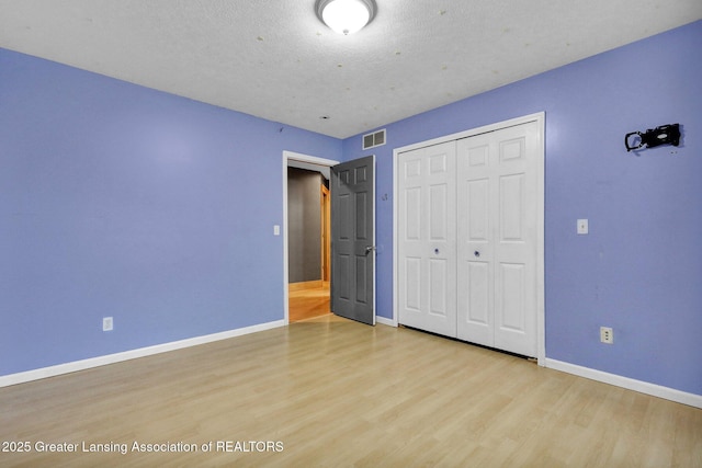 3650 Observatory Ln, Holt, MI 48842 - unfurnished bedroom with baseboards, wood finished floors, and a closet