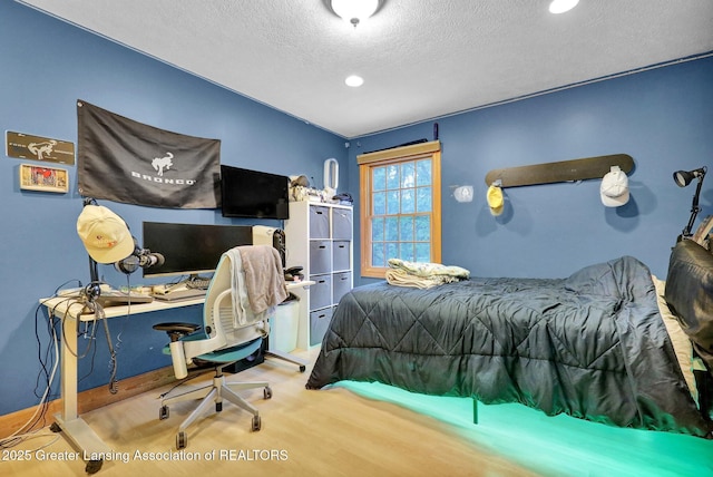 3650 Observatory Ln, Holt, MI 48842 - bedroom with wood finished floors, a textured ceiling, an office area, and recessed lighting