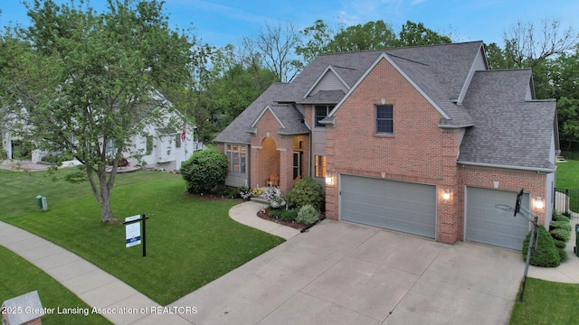 3650 Observatory Ln, Holt, MI 48842 - traditional-style house featuring concrete driveway, brick siding, a shingled roof, a front yard, and a garage