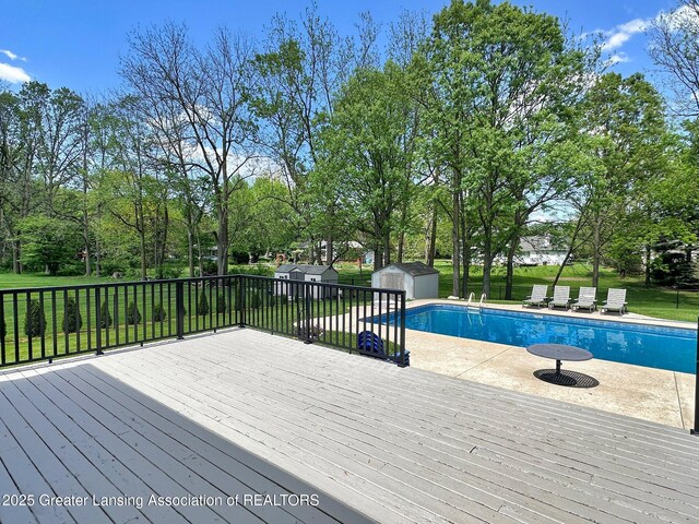 3650 Observatory Ln, Holt, MI 48842 - view of pool with a shed, an outbuilding, a wooden deck, and a yard