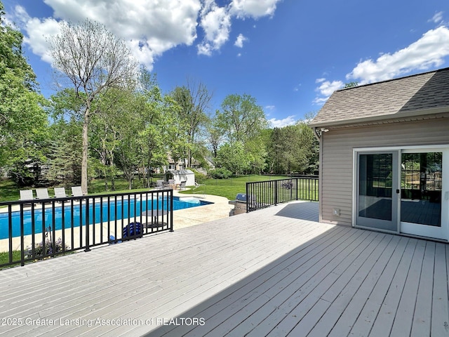 3650 Observatory Ln, Holt, MI 48842 - deck with an outdoor pool, an outdoor structure, a lawn, a storage shed, and view of wooded area