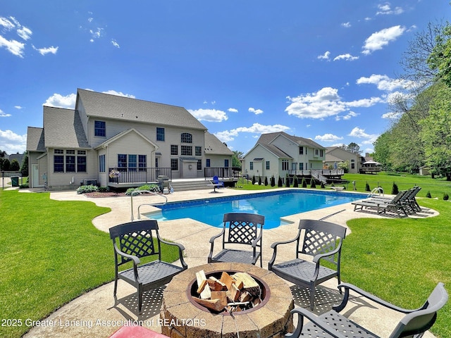 3650 Observatory Ln, Holt, MI 48842 - swimming pool featuring a fire pit, a wooden deck, and a patio
