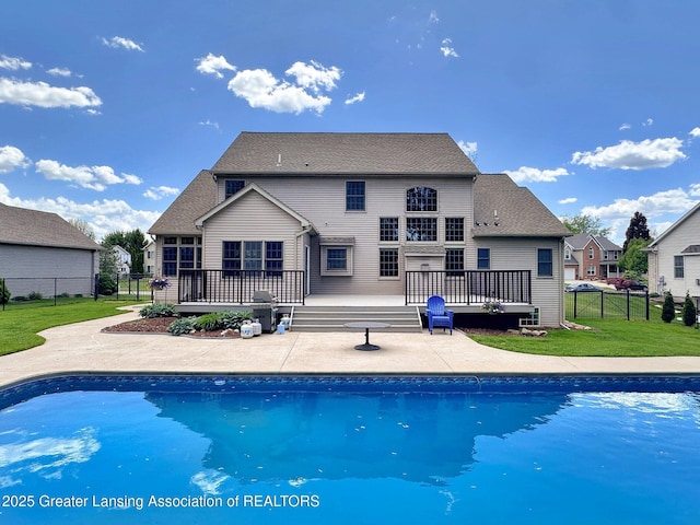 3650 Observatory Ln, Holt, MI 48842 - rear view of house featuring a wooden deck and an outdoor pool
