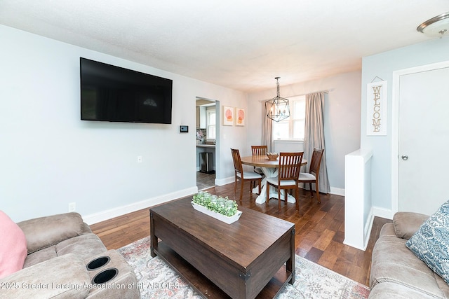 2531 Dillingham Ave, Lansing, MI 48906 - living area with a chandelier, wood finished floors, and baseboards