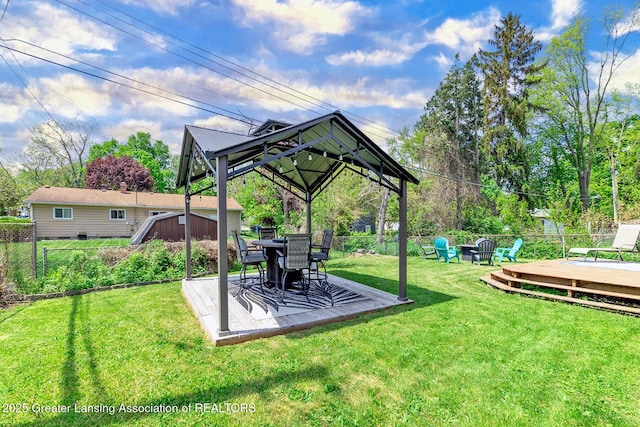 2531 Dillingham Ave, Lansing, MI 48906 - view of yard with a wooden deck, a gazebo, and an outdoor fire pit