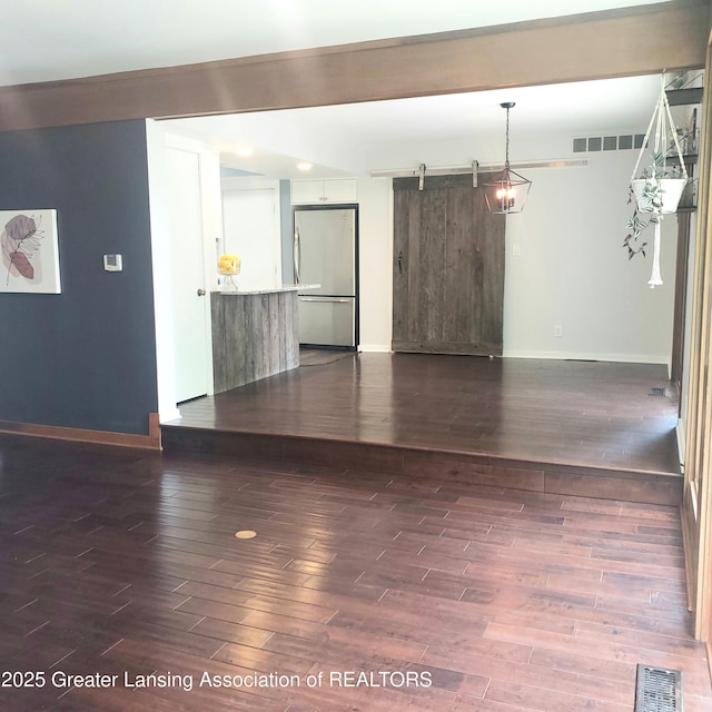 unfurnished room with baseboards and dark wood-type flooring