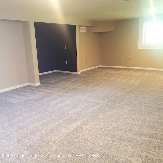 carpeted spare room with baseboards