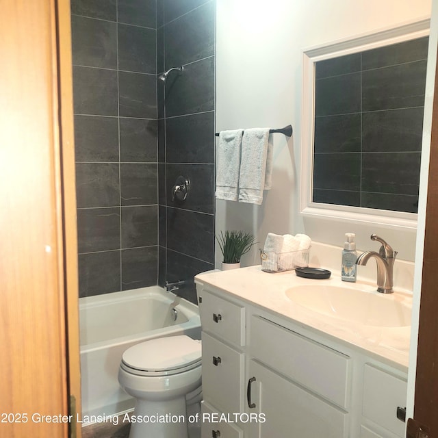 full bath with vanity, shower / tub combination, and toilet