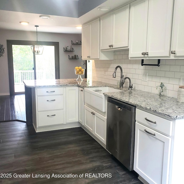 kitchen with stainless steel dishwasher, a peninsula, white cabinets, and recessed lighting