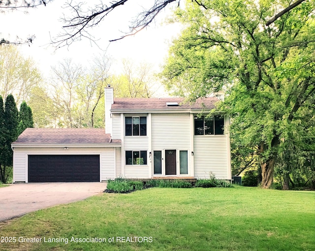 view of front of home featuring a chimney, a garage, a front lawn, and driveway