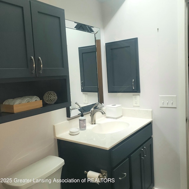 half bathroom featuring toilet and vanity