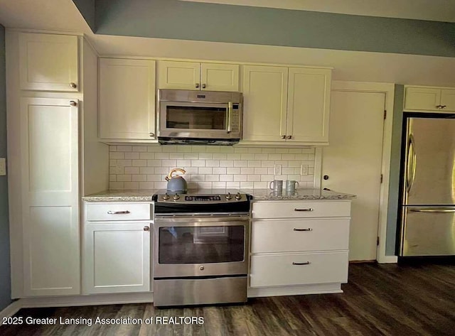 kitchen featuring appliances with stainless steel finishes, white cabinets, and dark wood-style floors