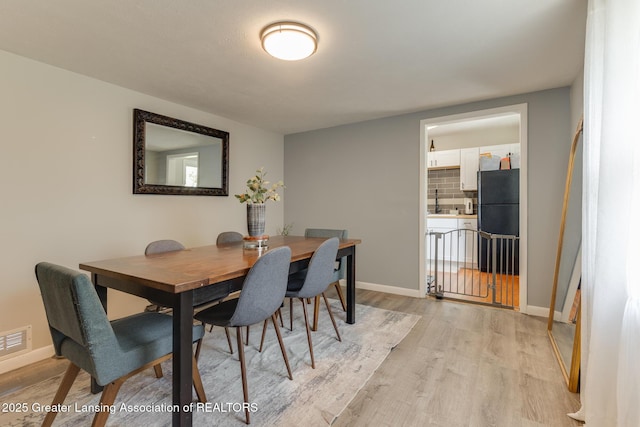 316 Union St, Grand Ledge, MI 48837 - dining space with light wood finished floors and baseboards