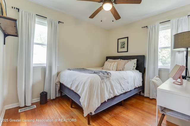 316 Union St, Grand Ledge, MI 48837 - bedroom with multiple windows, light wood-style flooring, baseboards, and ceiling fan