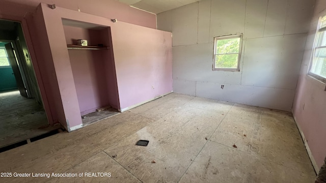 413 Meeker St, Leslie, MI 49251 - unfurnished bedroom with a closet and multiple windows