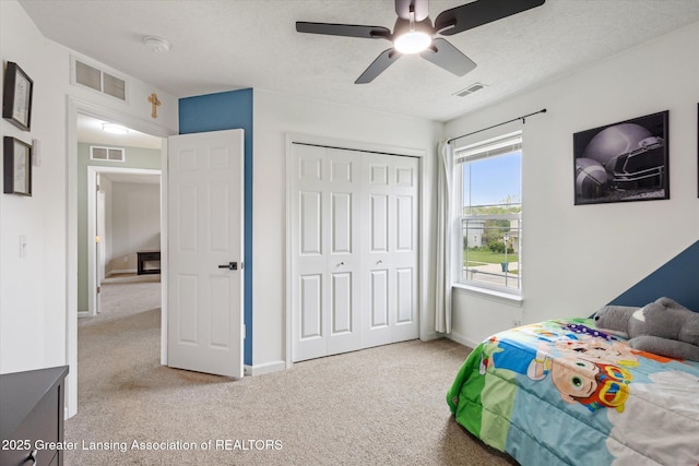 703 Josie Ln, Laingsburg, MI 48848 - carpeted bedroom with baseboards, a closet, ceiling fan, and a textured ceiling
