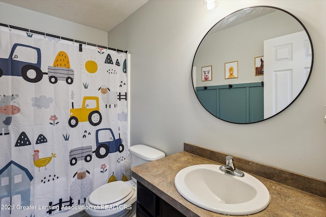 703 Josie Ln, Laingsburg, MI 48848 - bathroom with toilet, vanity, and a shower with shower curtain