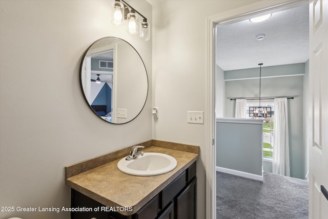 703 Josie Ln, Laingsburg, MI 48848 - bathroom featuring a chandelier and vanity
