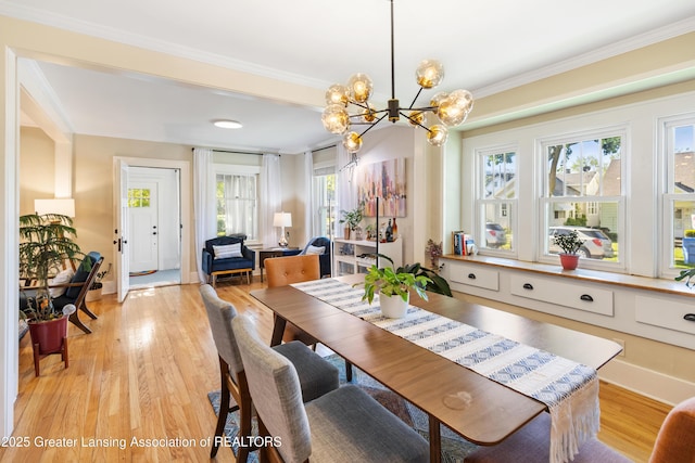 1038 Morgan St, Lansing, MI 48912 - dining room with a chandelier, light wood-type flooring, ornamental molding, and baseboards