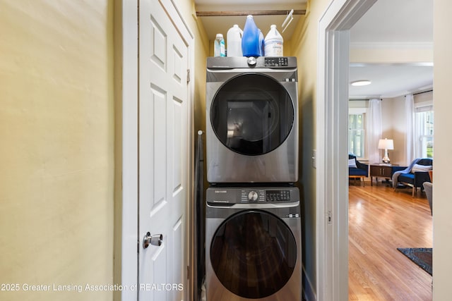 1038 Morgan St, Lansing, MI 48912 - washroom featuring estacked washer and dryer, wood finished floors, and ornamental molding