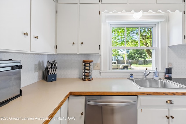 1038 Morgan St, Lansing, MI 48912 - kitchen featuring stainless steel dishwasher, light countertops, white cabinetry, and a sink